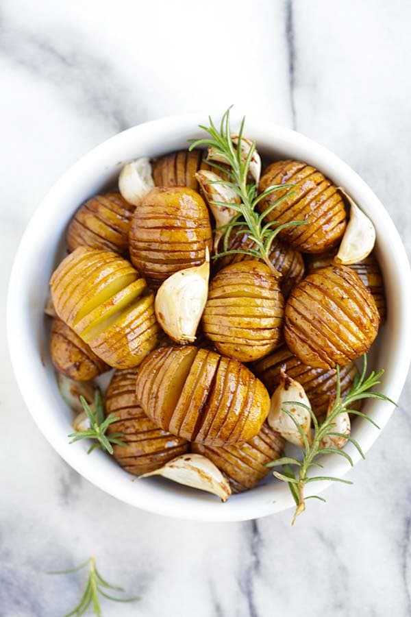 Easy and quick hasselback roasted potatoes with honey balsamic and garlic served in a bowl.