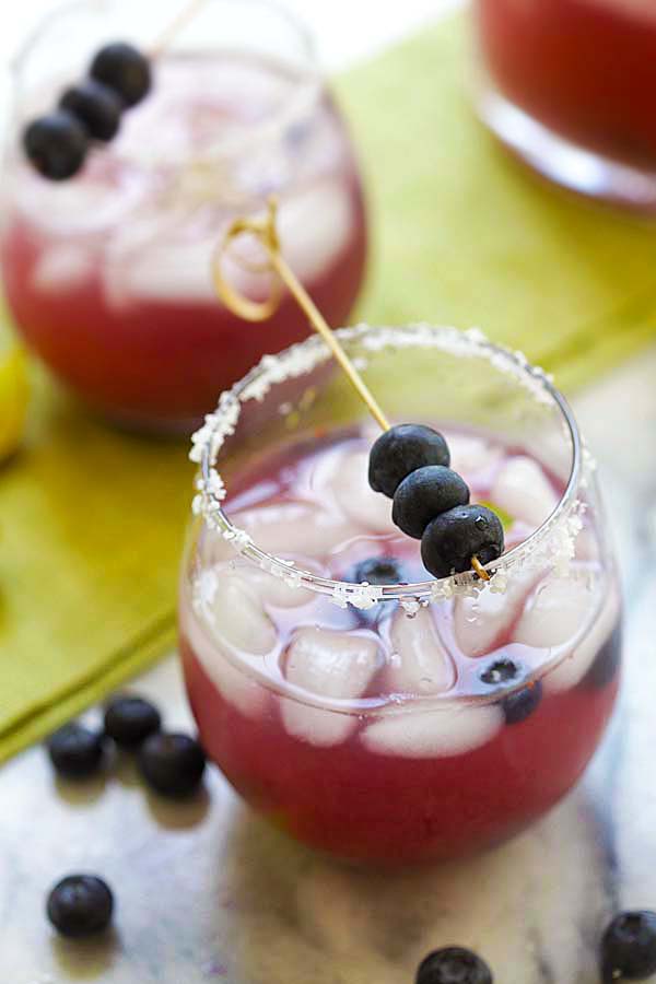 Easiest and booziest blueberry margarita recipe with silver tequila and blueberries served in a cocktail glass.