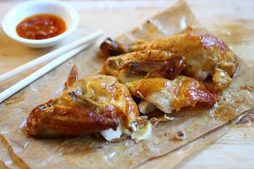 Hong Kong roasted chicken in pieces with a side of chili dipping sauce, ready to serve.