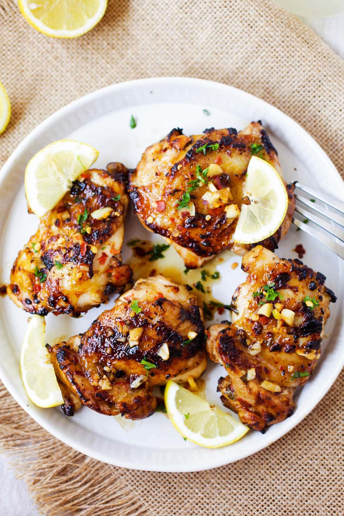 Easy and Delicious Lemon Garlic chicken, featuring chicken covered in lemon, garlic, honey, and parsley.