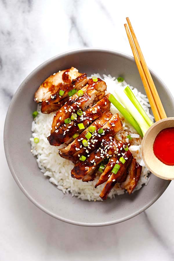 Easy and quick Asian soy-glazed chicken made with soy sauce, five spice powder and sugar served on top of rice in a bowl.
