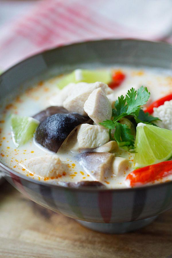 Healthy homemade and authentic Tom Kha Gai recipe with  chicken, mushroom and coconut milk ready to serve.
