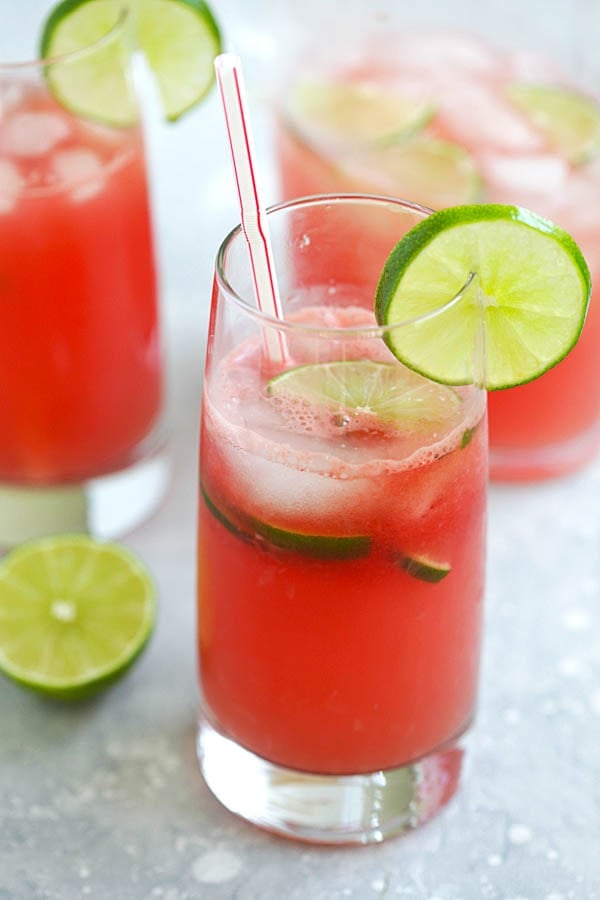 Refreshing and easy iced watermelon limeade served in a glass with a straw.
